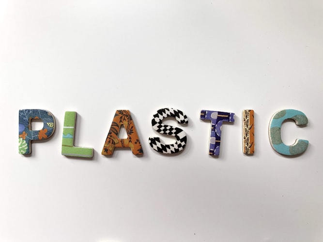 The word 'plastic' made out of plastic letters on a white background